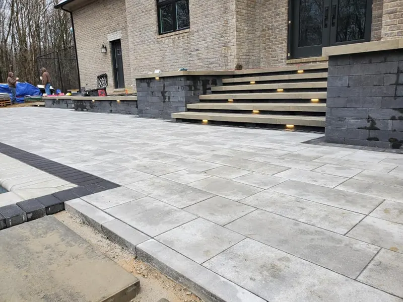 Paver patio with lit steps